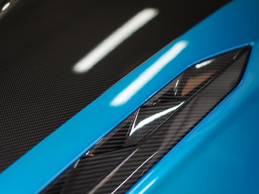 Close-up detail of paint protection film finish on a vehicle intake